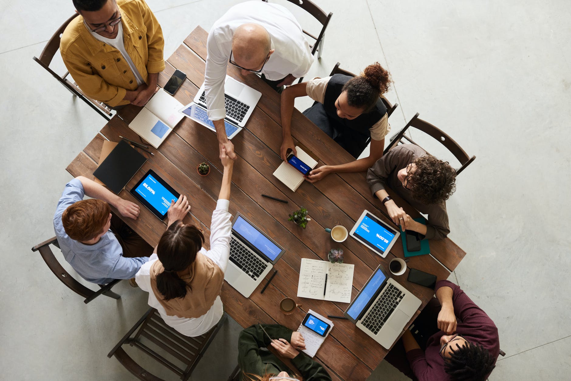 Group of people around a table working on laptops