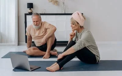 An older couple reviewing their pension performance on a laptop seeing how the time value of money has grown their wealth