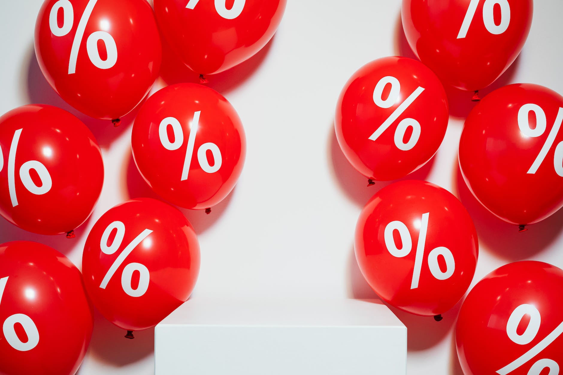 Red balloons with white percentage symbol on them